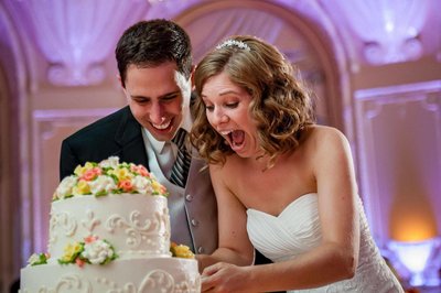 Joyful cake-cutting fun and a very expressive bride and groom