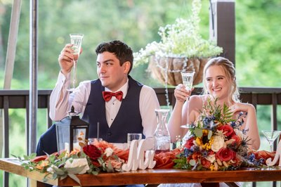 Elegant head table dinner toast at Fern Hill Barn