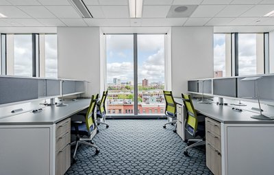 Open office with cubicles and window views Boston