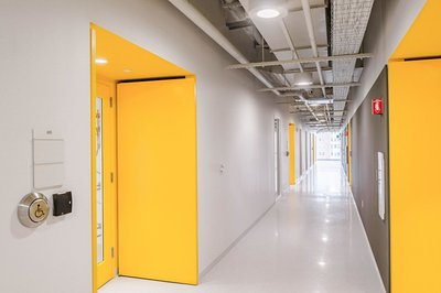Commercial lab space hallway with yellow accent door
