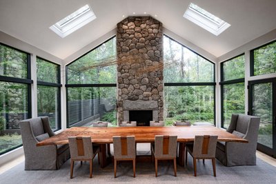 Vaulted ceiling dining room with stone fireplace