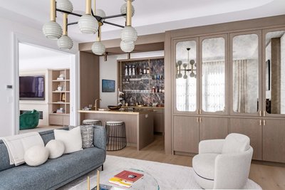 Warm neutral living room with built in bar cabinetry