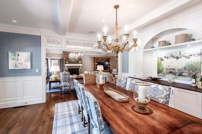 Formal dining room with chandelier and wall paneling