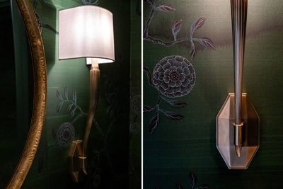 Close-up detail of wall sconce and floral wallpaper design