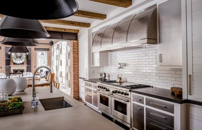 Gourmet kitchen with industrial range and exposed beams