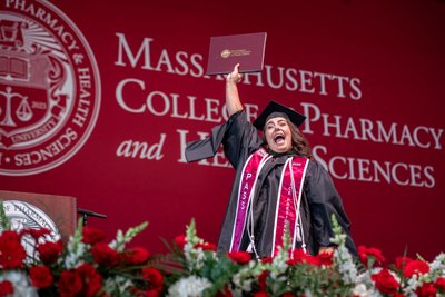 Graduate celebrating success at Boston commencement