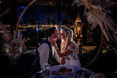 Intimate sweetheart table moment with night city view