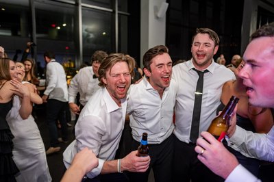 Groom celebrating with friends on the dancefloor