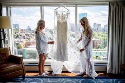 Bride and mom looking at dress before getting ready