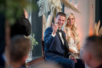 Groom smiling during a wedding speech