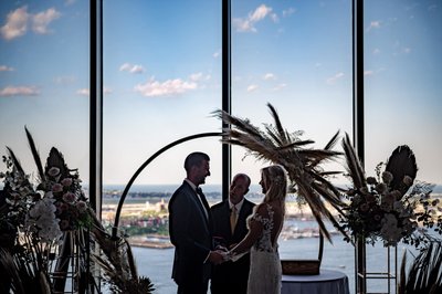 Silhouette photo with Boston skyline and floral arch
