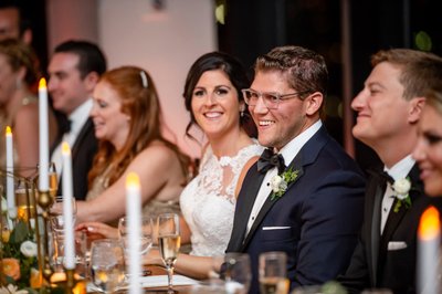Bride and groom laughing during toasts