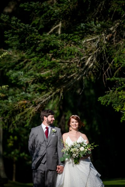 Couple walking to their ceremony at Blithewold Mansion wedding