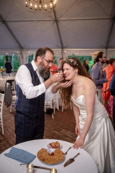 Couple sharing wedding pie at Long Hill reception in Beverly