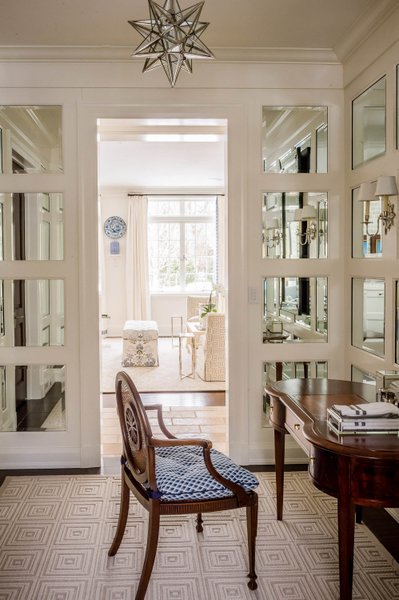 Transitional sitting area with natural light and glass doors