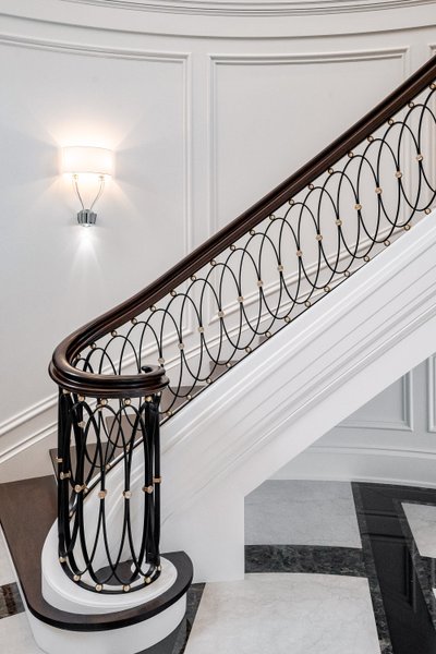 Architectural staircase with detailed custom wrought iron railing