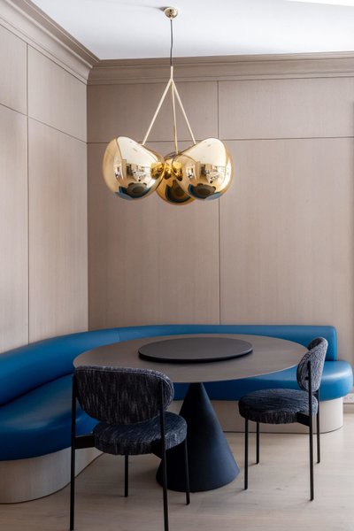 Sculptural light fixture over round dining banquette