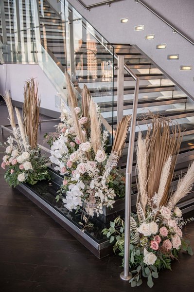Floral aisle setup on glass staircase landing