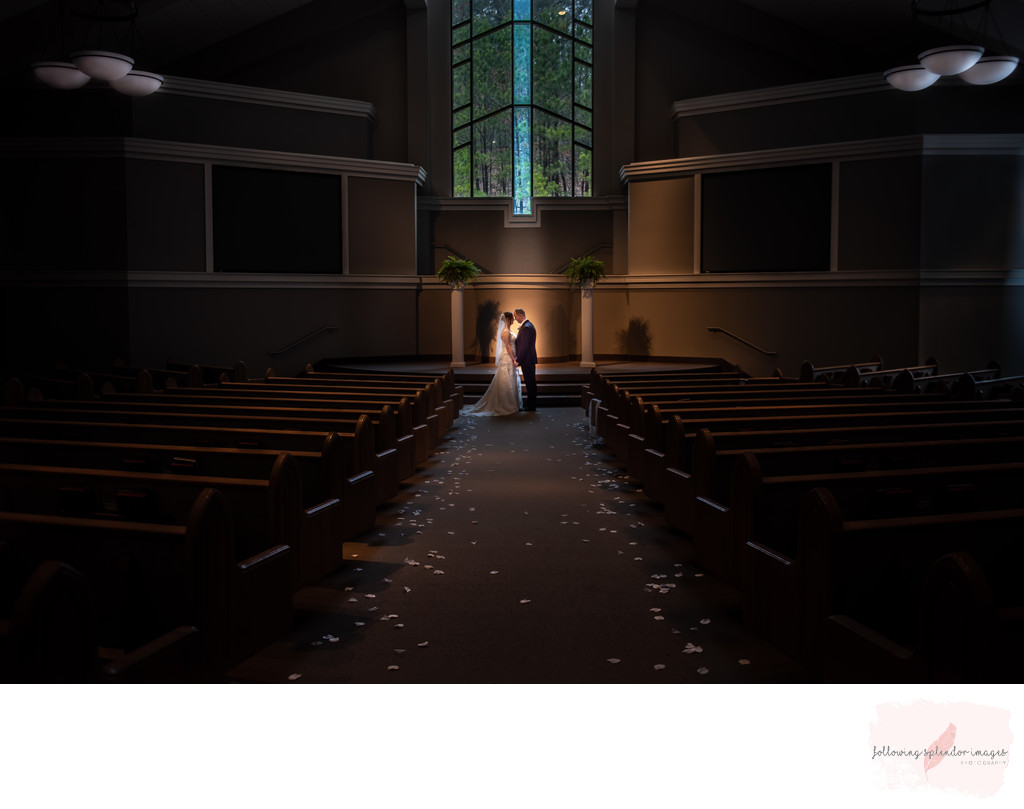 Wedding portrait in a beautiful church in front of windows
