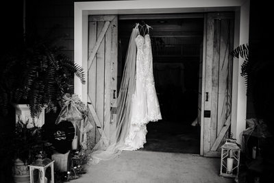 Wedding Dress hanging from Barn