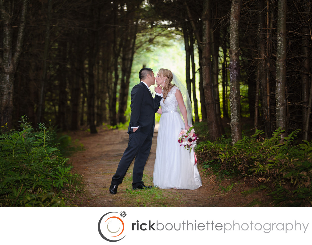 BRIDE AND GROOM IN THE FOREST AT BISHOP FARM WEDDING