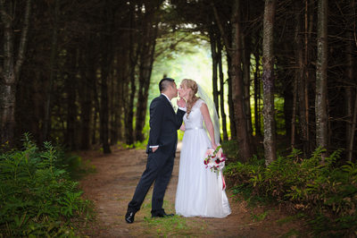 BRIDE AND GROOM IN THE FOREST AT BISHOP FARM WEDDING