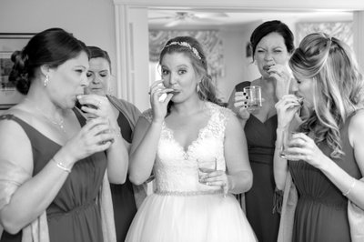 BRIDE AND BRIDESMAIDS HAVE A SHOT OF TEQUILA