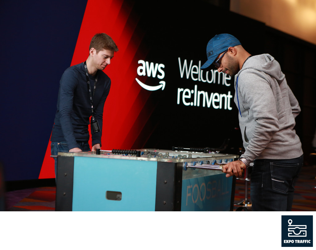 Foosball players in front of AWS branding