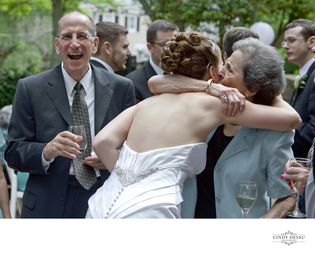 Fun Candid Photo of Hugs and Laughs During Receiving Line
