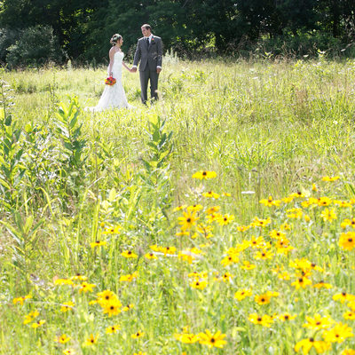 Bride and Groom in Field of Yellow at Holly Hedge Wedding