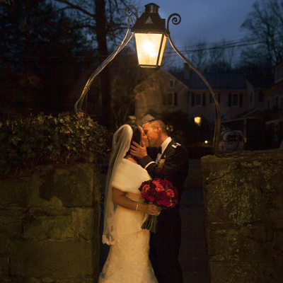 Holly Hedge Wedding Kiss in the Warm Glow of Dusk Photo