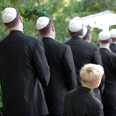 Candid Photo as Ring Bearer tries to Watch Jewish Wedding