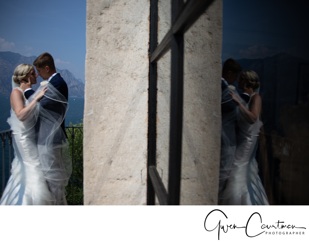 Bride and her veil on balcony, Malcesine Castle, Italy