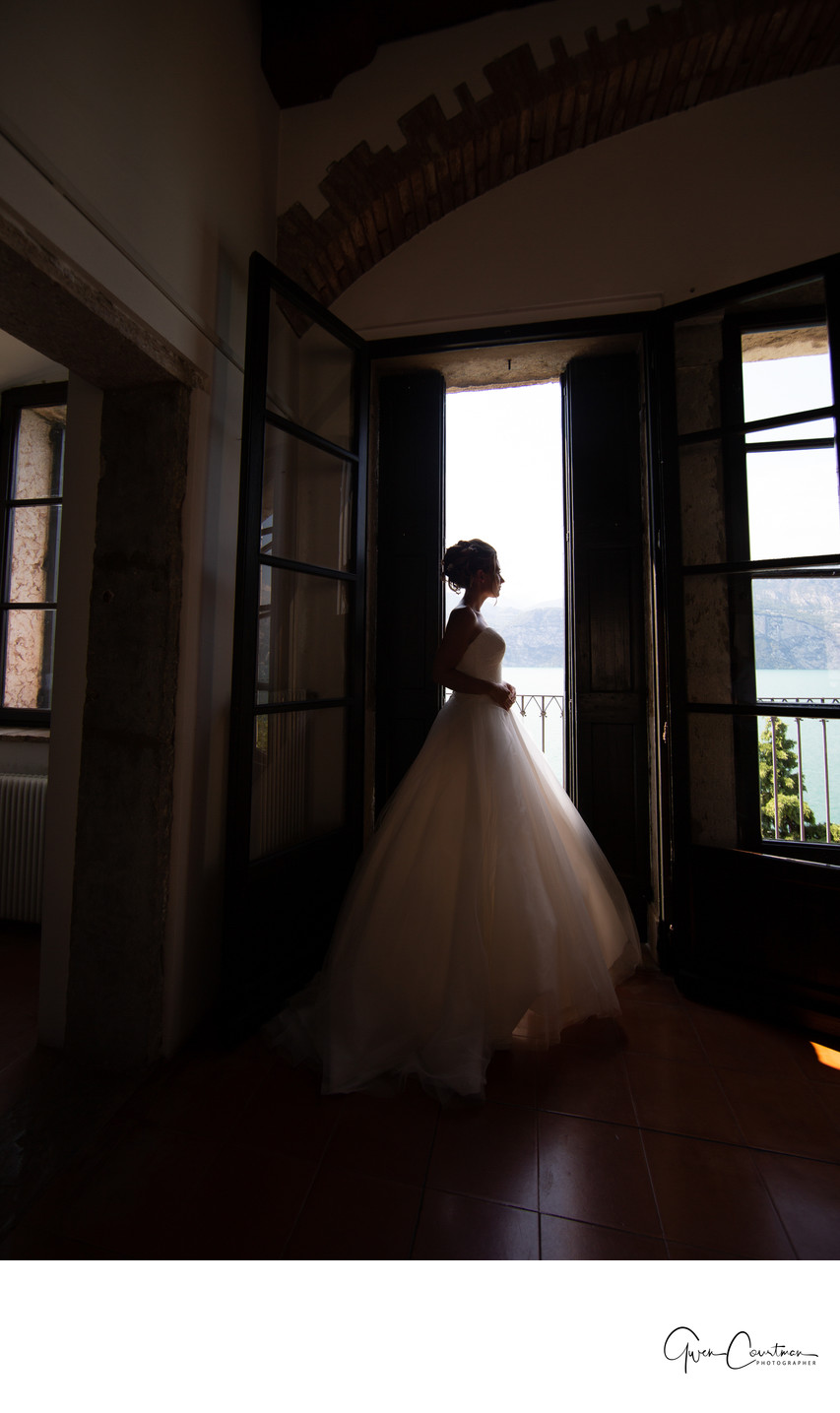 The thinking bride in a doorway in Malcesine Castle, IT
