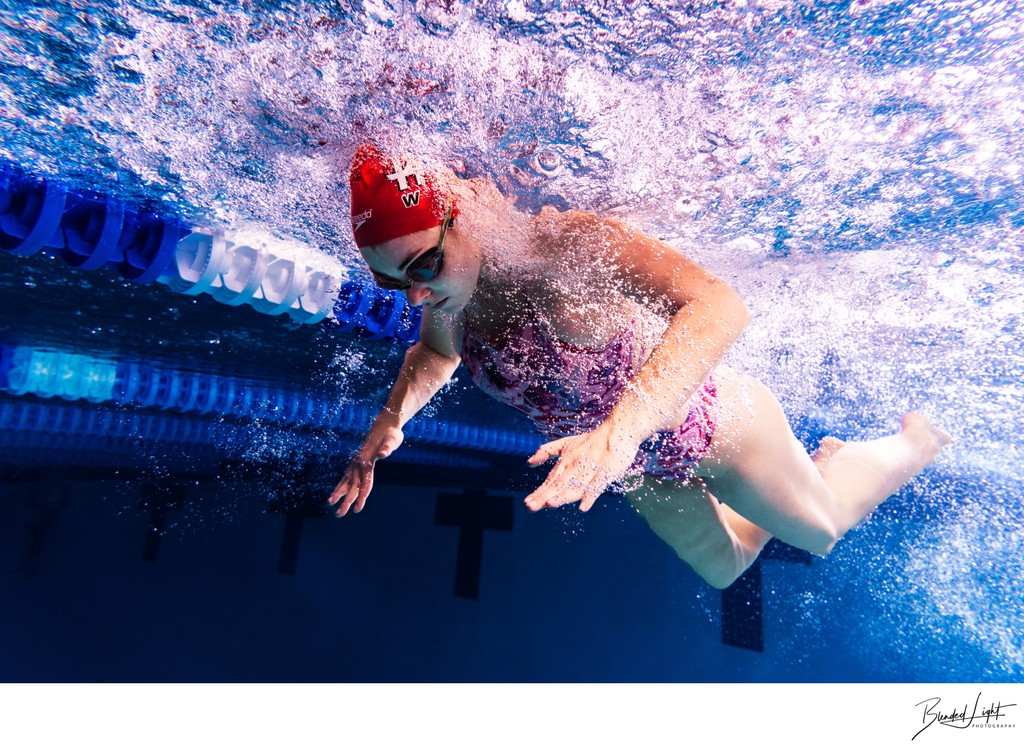 Underwater image of butterfly swimmer mid stroke