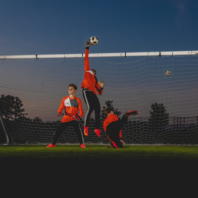 Composite image of goalie blocking the soccer shot