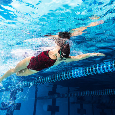 Freestyle swimmer in red suit image captured underwater