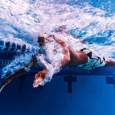 Underwater image of butterfly stroke with local swimmer