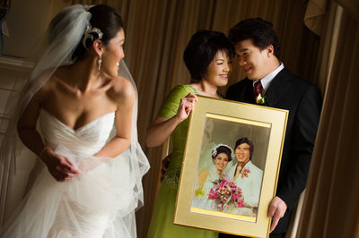Bride and Parents with their Wedding Photo