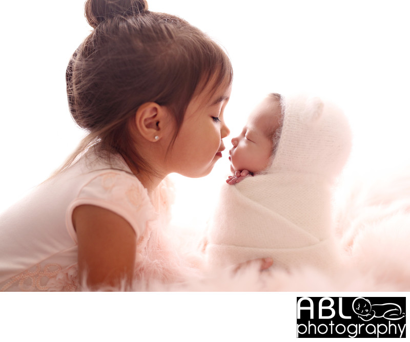 Newborn photography San Diego, sibling nose to nose pose