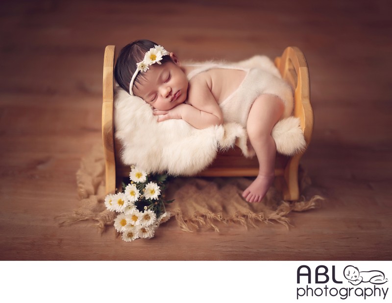 Baby on the cradle in newborn photo studio Poway, CA