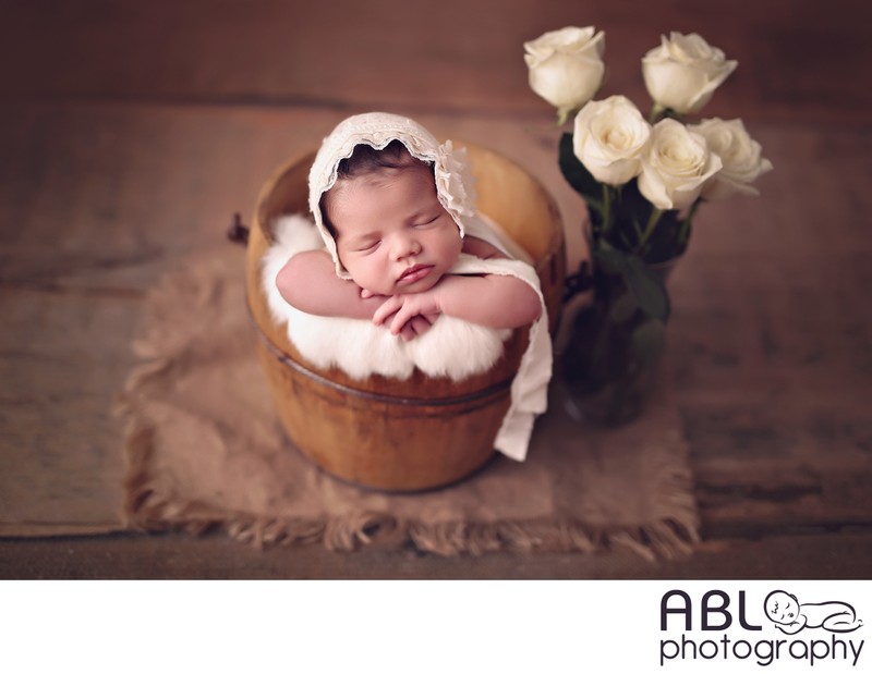 Newborn baby girl with flowers