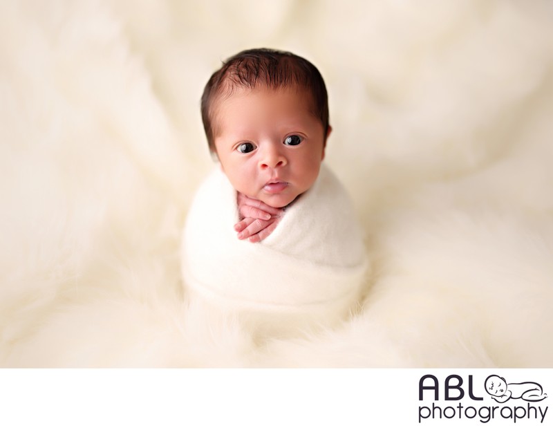 San Diego newborn session with wide-awake wrapped baby