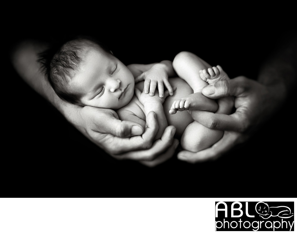 San Diego newborn photography with hands holding newborn