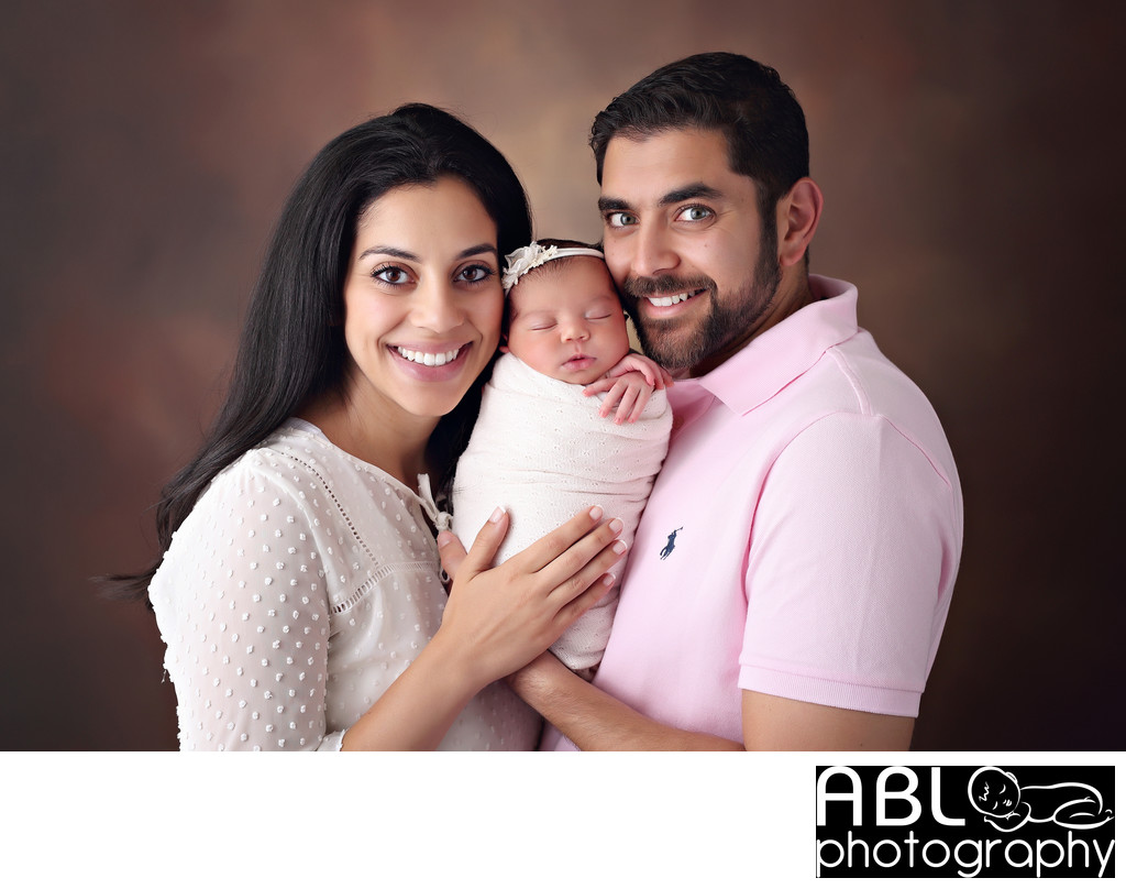Parents smiling with newborn