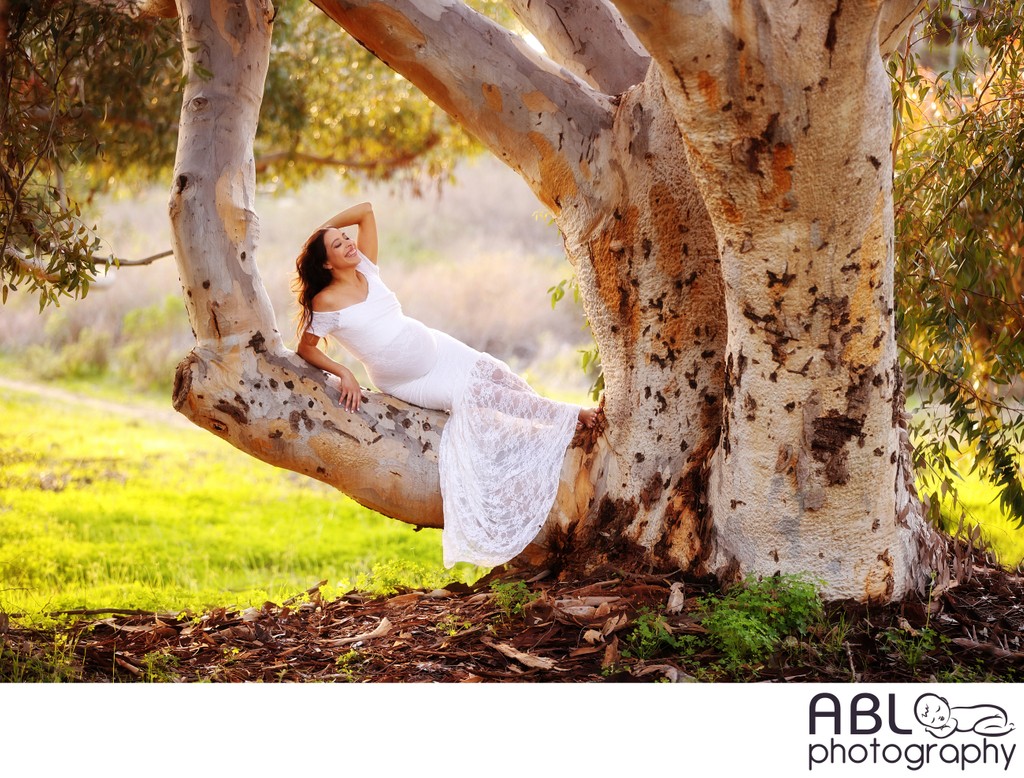 Pregnant women lying on big tree