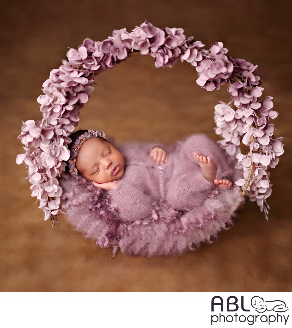 Baby in purple flower wreath