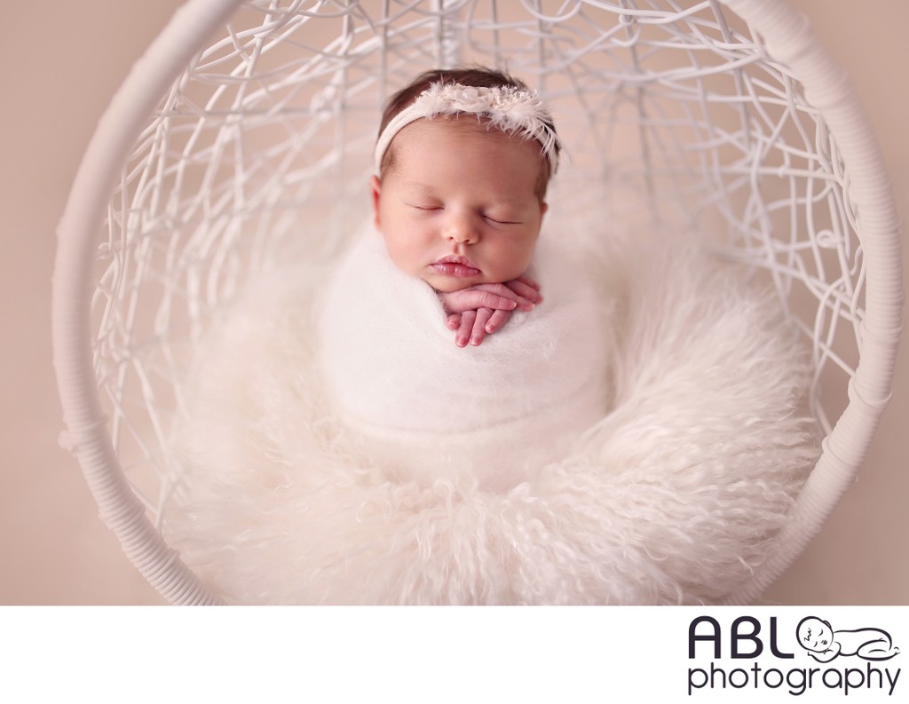 Baby in cream hanging basket