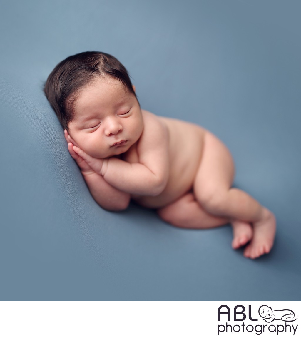 Newborn photos of baby boy on blue background