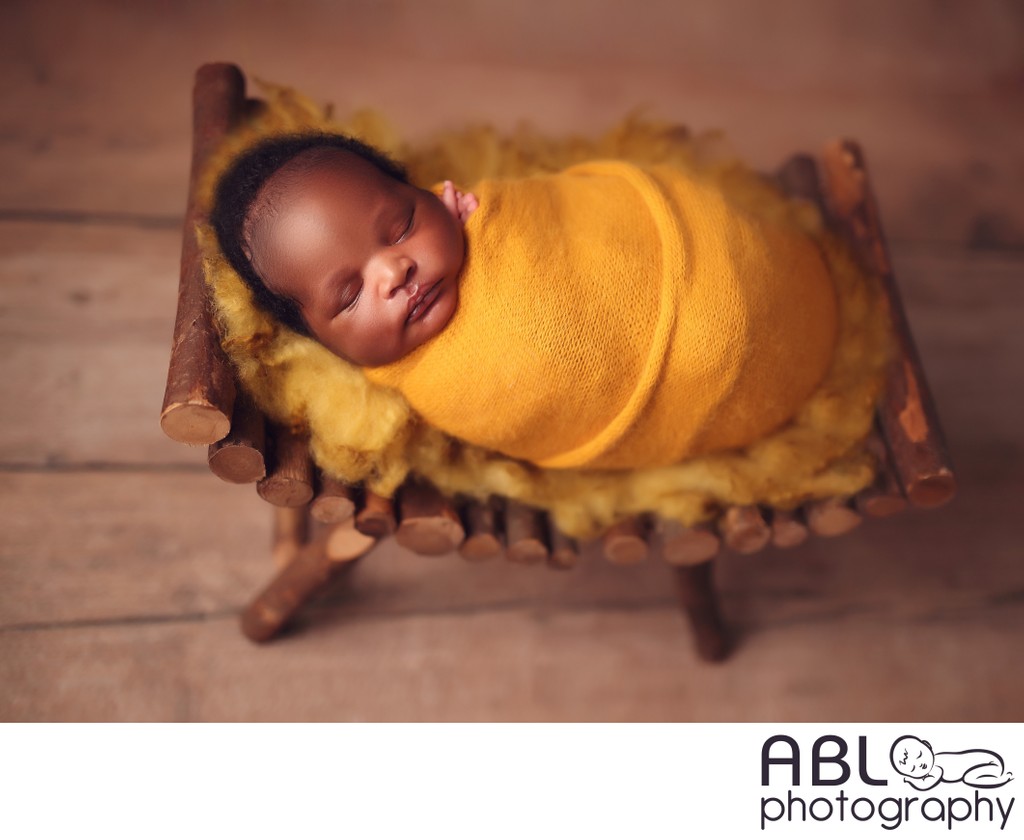 African American baby wrapped in yellow